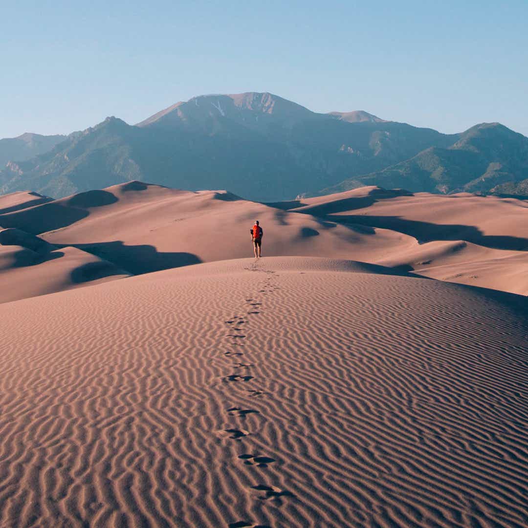 person walking in desert